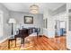 Elegant living room featuring a piano and hardwood floors at 904 Watermelon Run, Charleston, SC 29412
