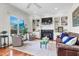 Bright living room featuring a fireplace, built-in shelving, hardwood floors, and comfortable seating at 904 Watermelon Run, Charleston, SC 29412