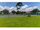Community features a tennis court surrounded by trees, a fence, and grass perfect for recreation at 904 Watermelon Run, Charleston, SC 29412