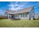 The backyard features a firepit, lawn, and screened-in porch at 9981 Winged Elm St, Ladson, SC 29456
