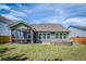 Exterior view of backyard featuring a screen porch, fire pit and lawn at 9981 Winged Elm St, Ladson, SC 29456