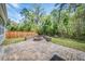 Paver patio with built-in fire pit and view of fenced yard at 9981 Winged Elm St, Ladson, SC 29456
