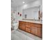 Bathroom with wood cabinets, granite countertop, and a shower with a floral curtain at 9981 Winged Elm St, Ladson, SC 29456