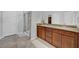 Bathroom features a granite countertop vanity, tiled floor, and a glass-enclosed shower at 9981 Winged Elm St, Ladson, SC 29456
