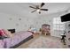 This bedroom has a ceiling fan, a doll house, and a makeup vanity at 9981 Winged Elm St, Ladson, SC 29456