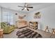 This bedroom has a crib, a furry rug, and a comfortable green chair at 9981 Winged Elm St, Ladson, SC 29456