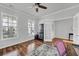 Bright bedroom features two windows, a ceiling fan, and french doors at 9981 Winged Elm St, Ladson, SC 29456