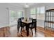 Sunlit dining area with dark wood table, wine rack, and sliding glass doors at 9981 Winged Elm St, Ladson, SC 29456