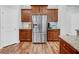 Well-lit kitchen features stainless steel refrigerator and granite countertops at 9981 Winged Elm St, Ladson, SC 29456