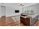 Spacious living room with hardwood floors, a large sectional sofa, and a wall-mounted TV at 9981 Winged Elm St, Ladson, SC 29456