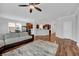 Open-concept living room with hardwood floors, a large sectional sofa, and a view of the kitchen at 9981 Winged Elm St, Ladson, SC 29456