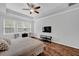 Main bedroom featuring tray ceiling, hardwood floors, a TV and an abundance of natural light at 9981 Winged Elm St, Ladson, SC 29456
