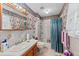 Bright bathroom with floral wallpaper and combination shower and bathtub at 102 Wright Ln, Goose Creek, SC 29445