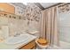Bathroom featuring floral wallpaper, tile, and a shower-tub combination at 102 Wright Ln, Goose Creek, SC 29445