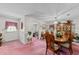 Formal dining room featuring wood furniture, china cabinet and pink carpet at 102 Wright Ln, Goose Creek, SC 29445