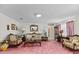 Cozy living room featuring ornate furniture, floral decor, and pink carpet at 102 Wright Ln, Goose Creek, SC 29445