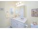 Bright bathroom with a white vanity, countertop, toilet, and a mirror with a view of the bathtub and shower at 1025 Riverland Woods Pl # 801, Charleston, SC 29412