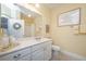 Bright bathroom features a white vanity, countertop, toilet, and a mirror reflecting the bathtub and shower at 1025 Riverland Woods Pl # 801, Charleston, SC 29412