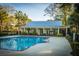 Community pool with lounge area and clubhouse perfect for recreation at 1025 Riverland Woods Pl # 801, Charleston, SC 29412