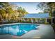 Community pool with palm trees, sundeck, and clubhouse for relaxing days at 1025 Riverland Woods Pl # 801, Charleston, SC 29412