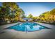 Community pool and clubhouse nestled amongst trees and blue skies at 1025 Riverland Woods Pl # 801, Charleston, SC 29412