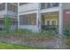 Close up view of a condo unit entrance with screen porch, American flag and lush green landscape at 1025 Riverland Woods Pl # 801, Charleston, SC 29412