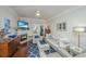 Well-appointed living room featuring a cozy fireplace, hardwood floors, and access to a private balcony for outdoor enjoyment at 1025 Riverland Woods Pl # 801, Charleston, SC 29412
