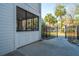 Covered outdoor patio with black metal railings, a screen door, and a view of palm trees and a parking area at 1025 Riverland Woods Pl # 801, Charleston, SC 29412