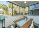 Inviting screened porch with dining table, seating, and natural light at 1025 Riverland Woods Pl # 801, Charleston, SC 29412