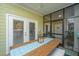 Cozy screened porch with dining area and view of exterior at 1025 Riverland Woods Pl # 801, Charleston, SC 29412