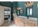 Bathroom with wood floors, double sink vanity, decorative wreath, and access to the main bedroom at 106 Sago Palm Ct, Summerville, SC 29483