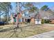 Charming brick home with well-maintained landscaping, a front-facing garage, and an inviting entrance at 106 Sago Palm Ct, Summerville, SC 29483