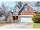 Charming two-story brick home featuring a well-maintained lawn, attached garage, and welcoming front porch at 106 Sago Palm Ct, Summerville, SC 29483