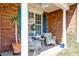 Inviting front porch featuring comfortable seating and a view of the front yard at 106 Sago Palm Ct, Summerville, SC 29483