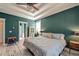 Bright main bedroom showcasing stylish furniture, unique wood floors, and tray ceilings at 106 Sago Palm Ct, Summerville, SC 29483