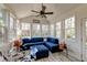 Cozy sunroom with vaulted ceilings, white shiplap walls, and comfortable blue seating at 106 Sago Palm Ct, Summerville, SC 29483