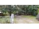Backyard view with a chain-link fence and mature trees at 107 Grant St, Walterboro, SC 29488