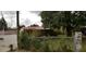 Backyard view with a chain-link fence and mature trees at 107 Grant St, Walterboro, SC 29488
