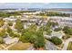 Aerial view of a neighborhood with colorful buildings and lush greenery near a bay and bridge at 1079 Lockhart St, North Charleston, SC 29405