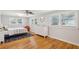A bright bedroom features hardwood floors, three windows, ceiling fan, and a stylish dresser at 1079 Lockhart St, North Charleston, SC 29405
