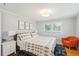 A cozy bedroom features hardwood floors, large windows, and a comfortable bed with patterned bedding at 1079 Lockhart St, North Charleston, SC 29405