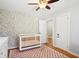 Bedroom featuring hardwood floors, stylish wallpaper, and a view to the hallway at 1079 Lockhart St, North Charleston, SC 29405