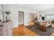 Open-concept dining area with hardwood floors, modern table, bench and natural light at 1079 Lockhart St, North Charleston, SC 29405