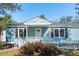 Charming light blue home with a white picket fence, front porch, and well-maintained landscaping at 1079 Lockhart St, North Charleston, SC 29405