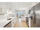 Bright kitchen with stainless steel appliances, tile backsplash, and a view into the dining area at 1079 Lockhart St, North Charleston, SC 29405