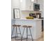 This stylish kitchen boasts a white countertop, modern appliances, white subway tile, and a wooden bowl filled with green apples at 1079 Lockhart St, North Charleston, SC 29405
