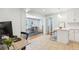 Bright kitchen featuring tile floors, white cabinets, a breakfast bar, and an adjacent dining area with wood floors at 1079 Lockhart St, North Charleston, SC 29405