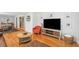Open living room featuring modern decor, a large television, and hardwood floors at 1079 Lockhart St, North Charleston, SC 29405