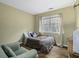 A cozy bedroom with a window, a TV, an accent chair and neutral-toned walls at 110 Mapperton Ct, Summerville, SC 29485