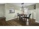 Dining area with hardwood floors and a pass-through to the kitchen offering a cozy spot for meals at 110 Mapperton Ct, Summerville, SC 29485